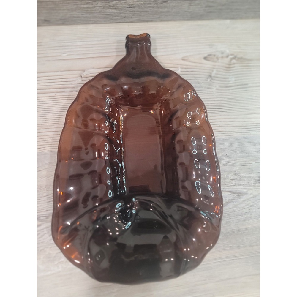 Melted growler made into display dish, serving, ashtray trinket tray amber glass